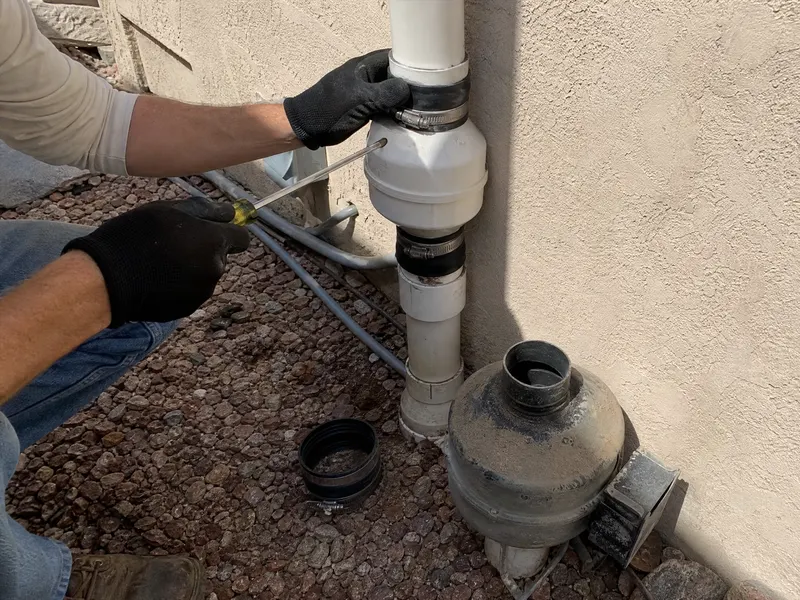Technician replacing a radon fan on an existing mitigation system in Phoenix AZ