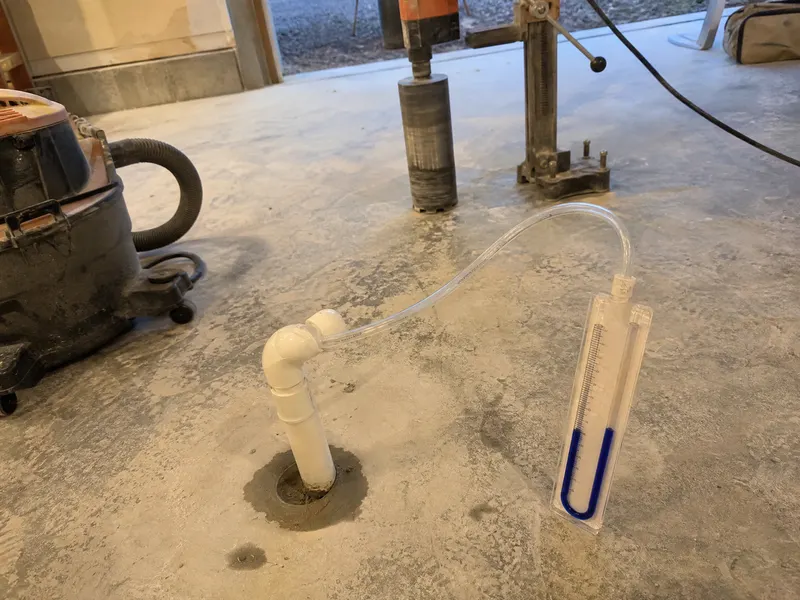 Sub-slab depressurization radon mitigation system pipe and fan on Arizona home